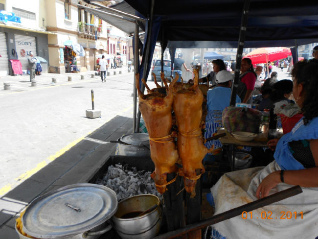 The ever present "Cuy" sold by a street vendor and a roasted pig at the market in Cuenca.