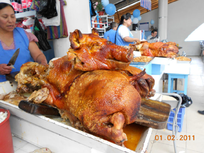 The ever present "Cuy" sold by a street vendor and a roasted pig at the market in Cuenca.